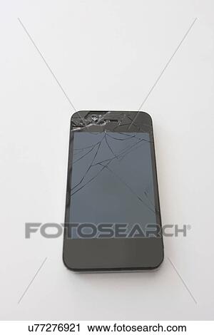 Stock Image - Smart phone with cracked screen over white background. Fotosearch