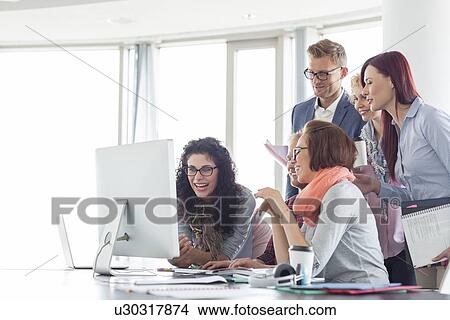 Smiling businesspeople working together at conference table View Large Photo Image Picture - Smiling businesspeople working together at conference table. Fotosearch