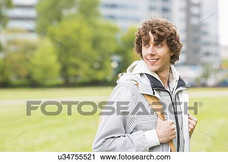 Smiling young male university student at college campus View Large Photo Image Stock Image - Smiling young male university student at college campus. Fotosearch