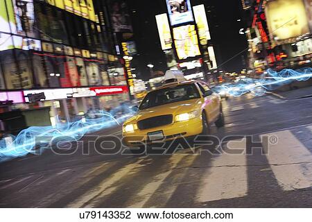 Stock Image - Taxi on city street at night. Fotosearch