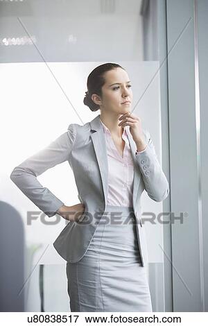 Stock Photo - Thoughtful young businesswoman in office. Fotosearch