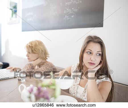 Thoughtful young woman having coffee in cafe View Large Photo Image Stock Photograph - Thoughtful young woman having coffee in cafe. Fotosearch