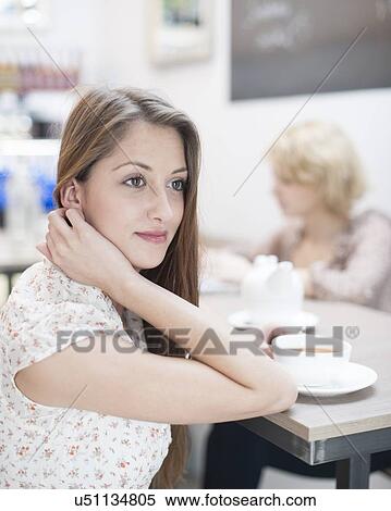 Thoughtful young woman having coffee in cafe View Large Photo Image Stock Photography - Thoughtful young woman having coffee in cafe. Fotosearch