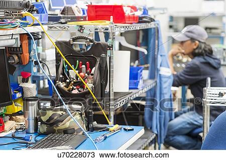 Tools on table with male technician in background at electronics industry View Large Photo Image Stock Image - Tools on table with male technician in background at electronics industry. Fotosearch