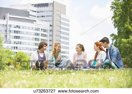 Stock Photo - University students studying together on campus ground. Fotosearch
