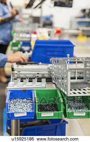 Stock Photograph - Variety of screws in tray at computer manufacturing industry. Fotosearch
