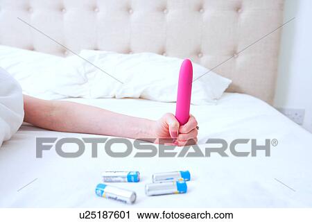 Woman holding a Pink Vibrator Dildo in Bed View Large Photo Image Stock Image - Woman holding a Pink Vibrator Dildo in Bed. Fotosearch