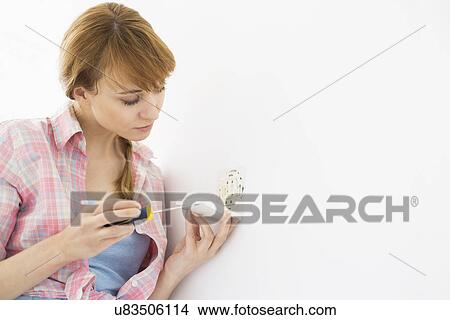 Woman working on electrical outlet View Large Photo Image Picture - Woman working on electrical outlet. Fotosearch