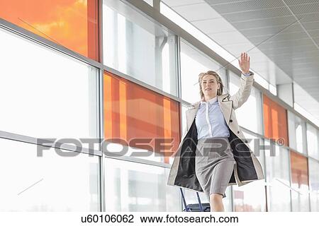Young businesswoman with luggage running in railroad station View Large Photo Image Stock Image - Young businesswoman with luggage running in railroad station. Fotosearch