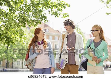 Young college students talking while walking on street View Large Photo Image Stock Image - Young college students talking while walking on street. Fotosearch