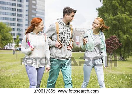 Young friends walking at college campus View Large Photo Image Stock Photography - Young friends walking at college campus. Fotosearch
