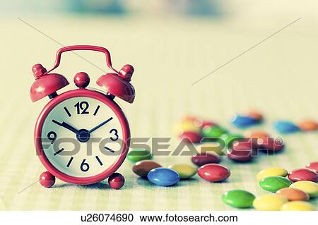 Alarm clock and confectionary View Large Photo Image Stock Image - Alarm clock and confectionary. Fotosearch