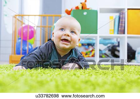 Baby crawling in nursery View Large Photo Image Stock Photo - Baby crawling in nursery. Fotosearch