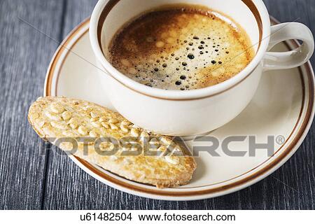 Picture - Coffee and a biscuit. Fotosearch