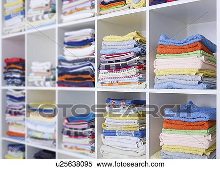Stock Photography - Folded towels on shelves. Fotosearch