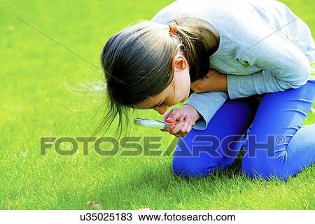 Girl using a magnifying glass View Large Photo Image Stock Image - Girl using a magnifying glass. Fotosearch