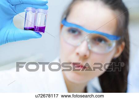 Stock Photo - Lab assistant holding samples. Fotosearch