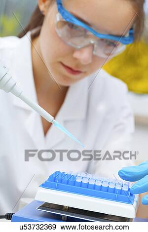 Stock Photo - Lab assistant using a pipette. Fotosearch
