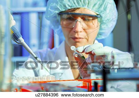 Stock Photograph - Lab technician using a pipette. Fotosearch