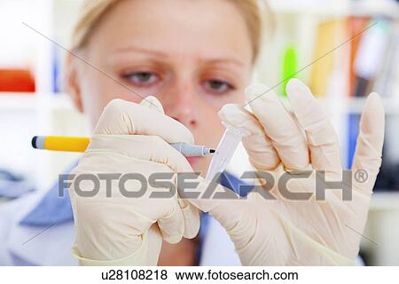 Lab technician writing on test tube View Large Photo Image Stock Photo - Lab technician writing on test tube. Fotosearch