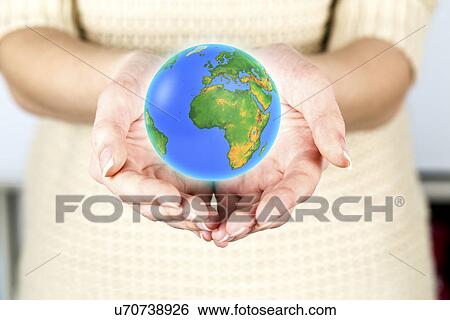 Person holding the globe in their hands View Large Photo Image Stock Photograph - Person holding the globe in their hands. Fotosearch