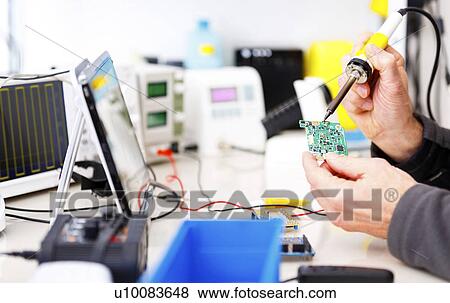 Person repairing electronic circuit board View Large Photo Image Stock Photo - Person repairing electronic circuit board. Fotosearch