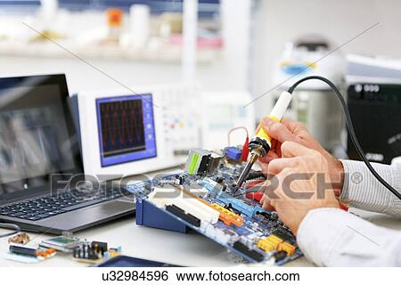 Person repairing electronic circuit board View Large Photo Image Stock Photograph - Person repairing electronic circuit board. Fotosearch