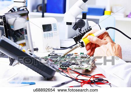 Picture - Soldering equipment and circuit board. Fotosearch