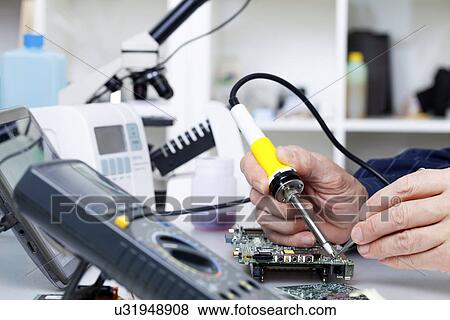 Stock Photo - Soldering equipment and electronic parts. Fotosearch