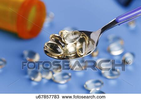 Spoon with capsules View Large Photo Image Stock Image - Spoon with capsules. Fotosearch