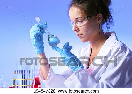 Stock Photo - Woman holding flask. Fotosearch