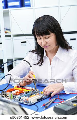 Stock Image - Woman making a micro processor. Fotosearch