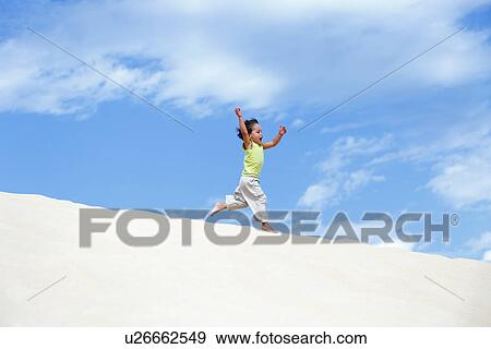Young boy running on sand dunes View Large Photo Image Stock Photo - Young boy running on sand dunes. Fotosearch