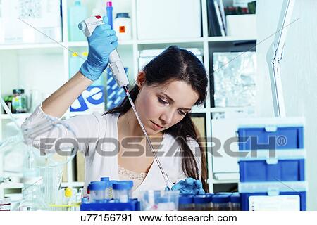 Young woman using pipette View Large Photo Image Stock Image - Young woman using pipette. Fotosearch