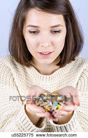 Young woman with capsules in her hands View Large Photo Image Stock Photography - Young woman with capsules in her hands. Fotosearch