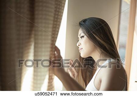Attractive woman looking out of window View Large Photo Image Stock Image - Attractive woman looking out of window. Fotosearch