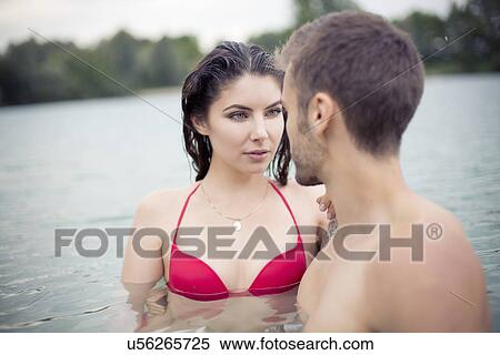 Attractive young couple standing face to face in lake View Large Photo Image Stock Photography - Attractive young couple standing face to face in lake. Fotosearch