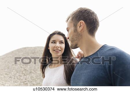 Attractive young couple strolling by gravel hill View Large Photo Image Picture - Attractive young couple strolling by gravel hill. Fotosearch