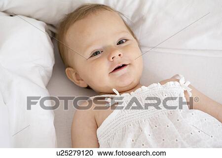 Baby girl lying down View Large Photo Image Stock Image - Baby girl lying down. Fotosearch