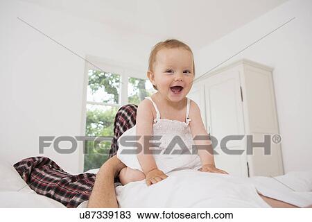 Stock Image - Baby girl smiling towards camera. Fotosearch