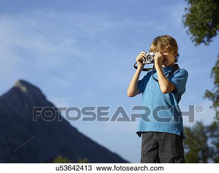 Boy photographing landscape using SLR camera, Majorca, Spain View Large Photo Image Stock Image - Boy photographing landscape using SLR camera, Majorca, Spain. Fotosearch