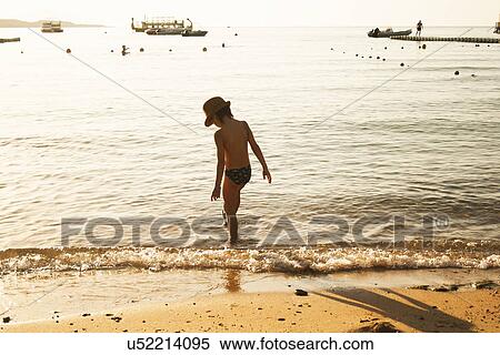 Boy playing by seaside, Sharm El Sheikh, Egypt View Large Photo Image Stock Photography - Boy playing by seaside, Sharm El Sheikh, Egypt. Fotosearch