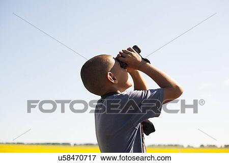 Boy using binoculars View Large Photo Image Stock Photo - Boy using binoculars. Fotosearch