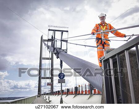 Bridge worker on cable of suspension bridge. The Humber Bridge, UK was built in 1981 and at the time was the world's largest single-span suspension bridge View Large Photo Image Stock Photo - Bridge worker on cable of suspension bridge. The Humber Bridge, UK was built in 1981 and at the time was the world's largest single-span suspension bridge. Fotosearch