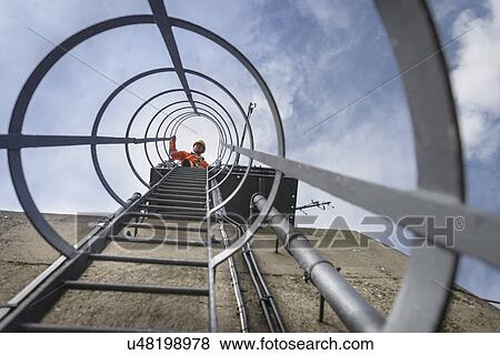 Stock Photo - Bridge worker on ladder on top of suspension bridge. The Humber Bridge, UK was built in 1981 and at the time was the world's largest single-span suspension bridge. Fotosearch