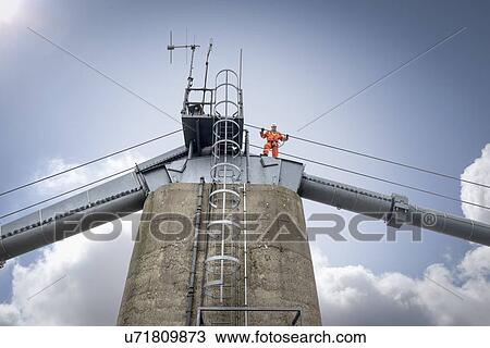 Stock Image - Bridge worker on top of suspension bridge. The Humber Bridge, UK was built in 1981 and at the time was the world's largest single-span suspension bridge. Fotosearch