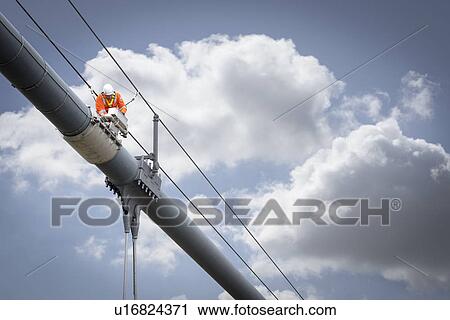 Bridge worker working on cable of suspension bridge. The Humber Bridge, UK was built in 1981 and at the time was the world's largest single-span suspension bridge View Large Photo Image Stock Image - Bridge worker working on cable of suspension bridge. The Humber Bridge, UK was built in 1981 and at the time was the world's largest single-span suspension bridge. Fotosearch