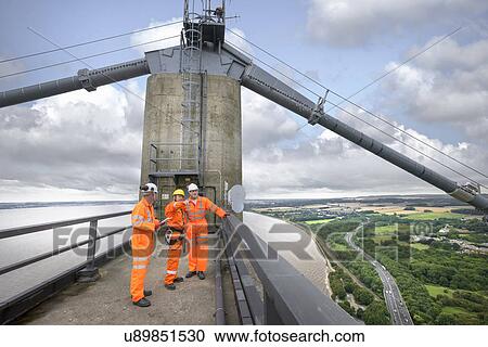 Bridge workers on top of suspension bridge. The Humber Bridge, UK was built in 1981 and at the time was the world's largest single-span suspension bridge View Large Photo Image Stock Image - Bridge workers on top of suspension bridge. The Humber Bridge, UK was built in 1981 and at the time was the world's largest single-span suspension bridge. Fotosearch