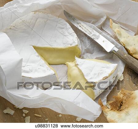 Stock Photo - Brie wrapped in paper. Fotosearch