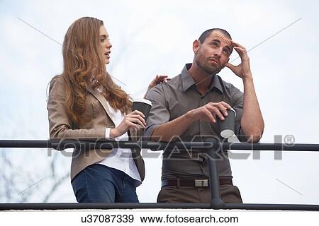 Stock Photo - Businessman and business woman having coffee. Fotosearch